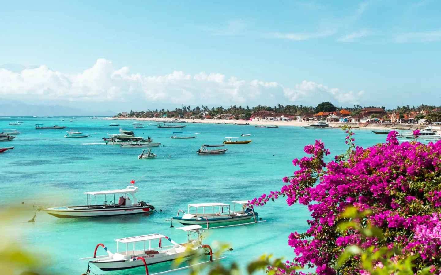 Boats on turquoise water near Jungutbatu